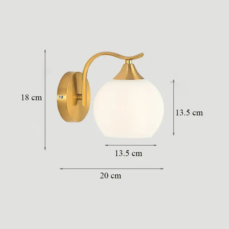 Classic brass glass wall sconce with gold-toned curved arm and frosted white spherical shade for bedroom decorbites brass glass