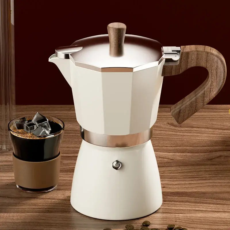 Cream-colored classic coffee machine moka pot with aluminum body, wood handle, and metallic bands for kitchen use