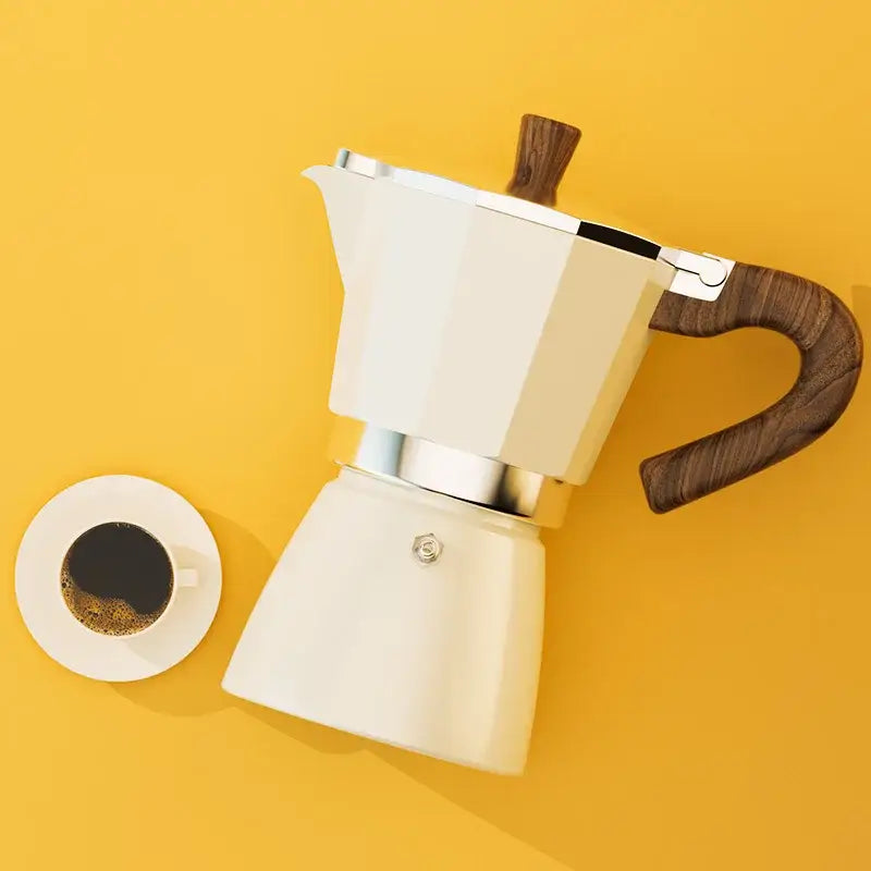 Classic cream aluminum moka pot coffee machine with polished wooden handle and silver metal accents for classic coffee brewing