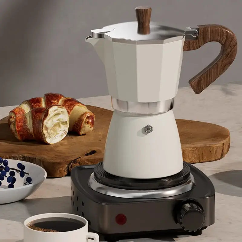 Classic cream aluminum moka pot coffee machine with white finish and wood handle for classic coffee brewing