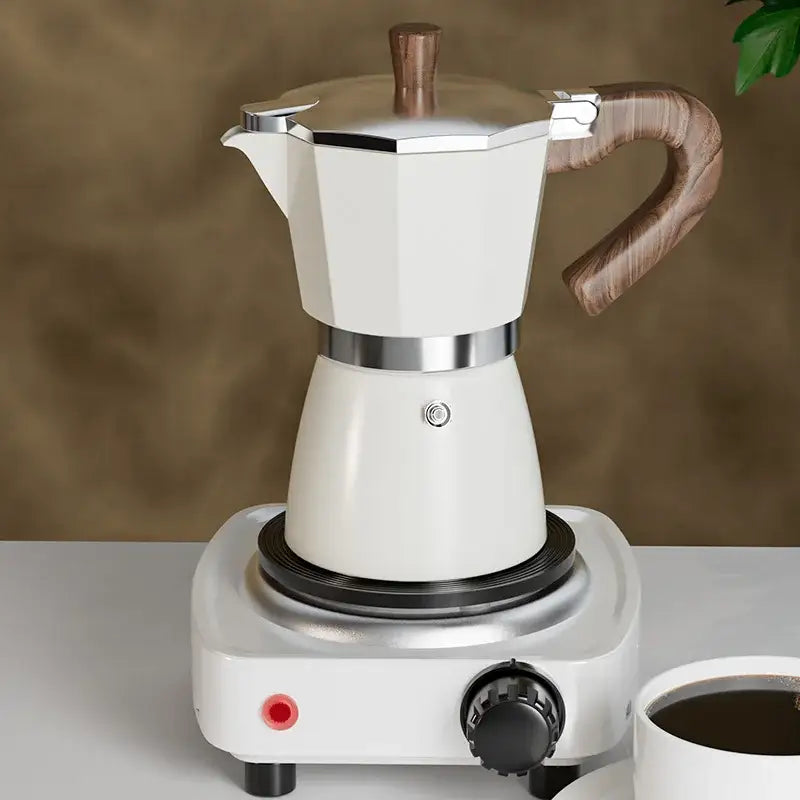Classic cream aluminum moka pot coffee machine with wood handle and knob on matching electric stove base