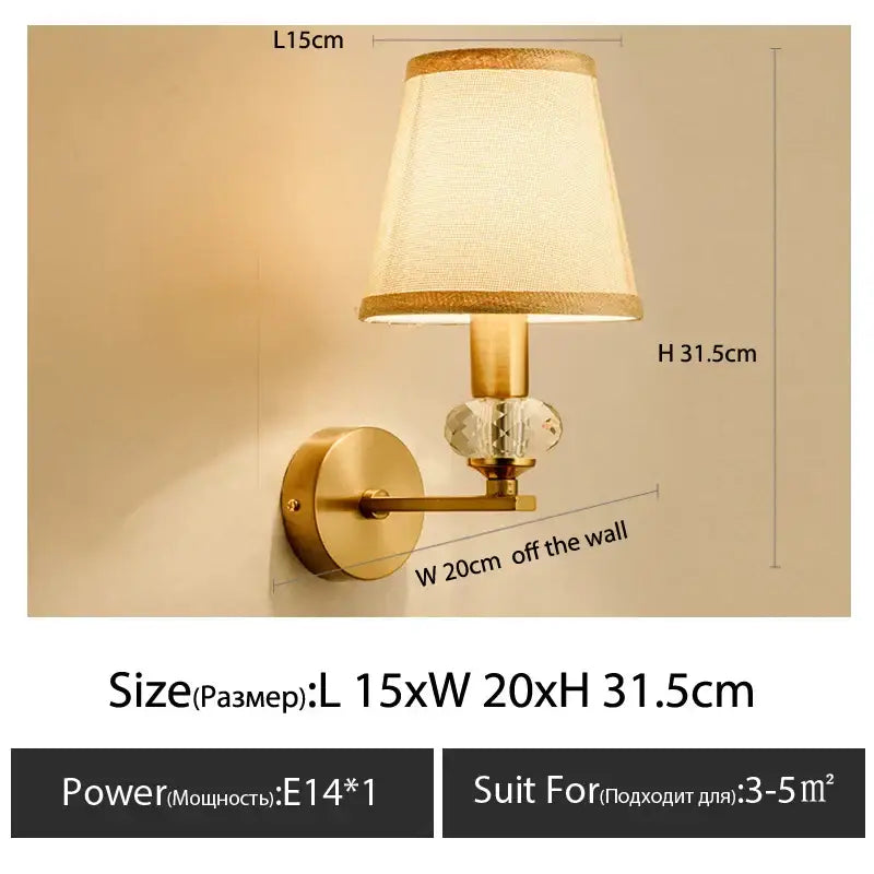 Gold-finished wall light with a textured beige decorbites cloth cover and faceted crystal accent for bedroom decor