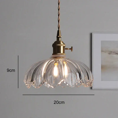 Classic glass clear ribbed pendant light with brass hardware and twisted cord for elegant dining room use