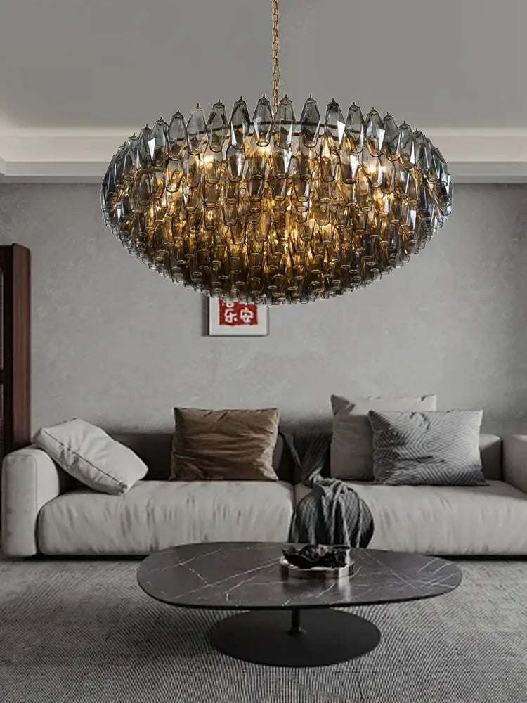 A modern oval-shaped pink glass chandelier with gold chain and faceted amber crystals for dining room lighting decorbites large pink