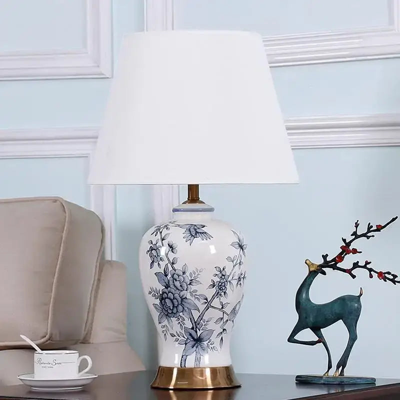 Classic white porcelain table lamp with blue floral hand-painted design and gold-toned base for living room decor