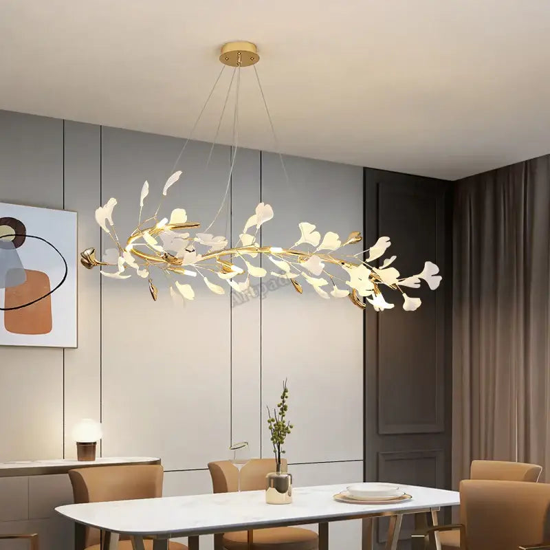 Elegant gold leaf pendant lamp with white leaf accents above modern dining table decorbites classic white lighting