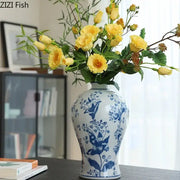 Classical blue and white porcelain vase with intricate floral patterns holding yellow roses for living room decorbites decor