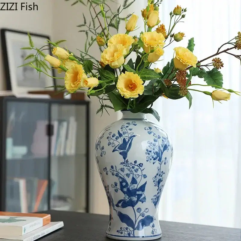 Classical blue and white porcelain vase with intricate floral patterns holding yellow roses for living room decorbites decor
