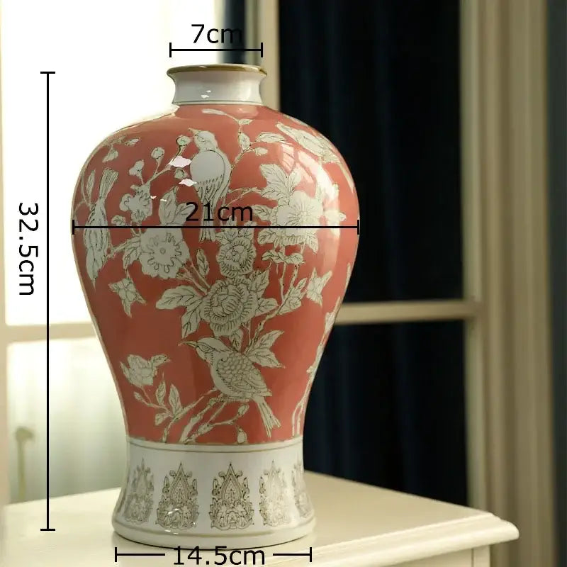 A coral-painted ceramic white porcelain vase with intricate white floral and bird motifs for decorbites blue decor
