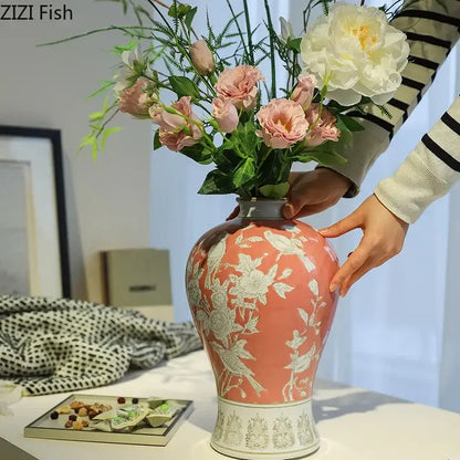 A coral-colored ceramic vase with intricate white floral and bird patterns for classical blue and white porcelain decorbites decor