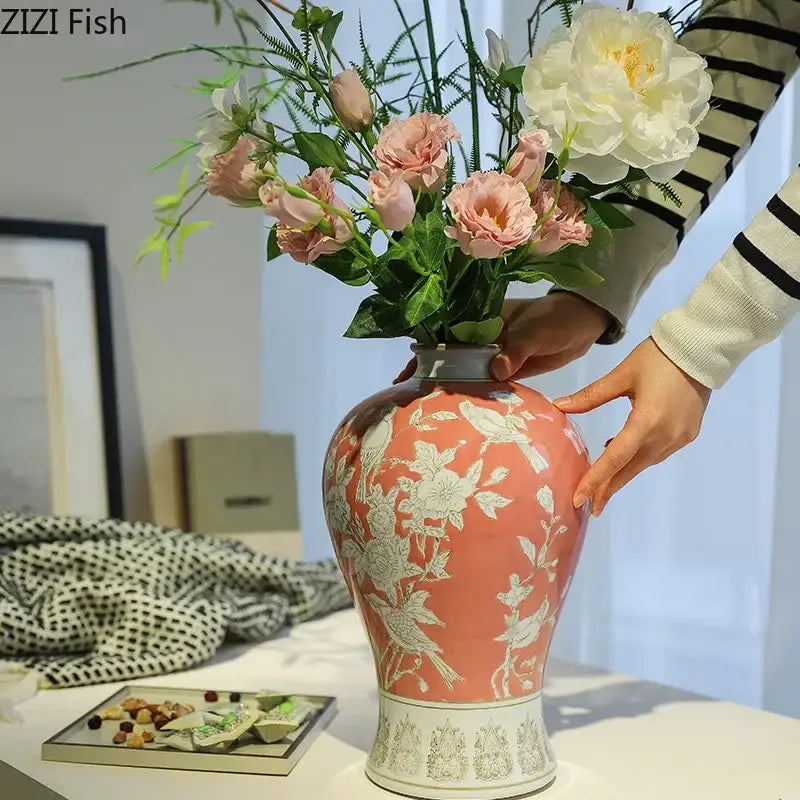 A coral-colored ceramic vase with intricate white floral and bird patterns for classical blue and white porcelain decorbites decor