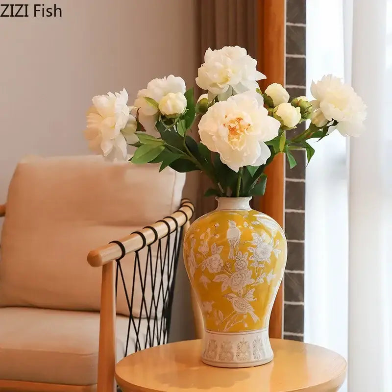 A yellow ceramic vase with white floral and bird motifs and decorative base for classical blue and white porcelain decorbites white porcelain vase
