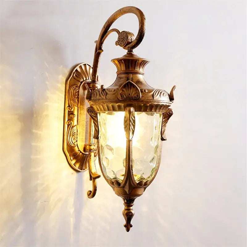 Classical bronze led outdoor wall lamp with antique brass finish, textured amber glass, and ornate leaf decorbites bronze led design