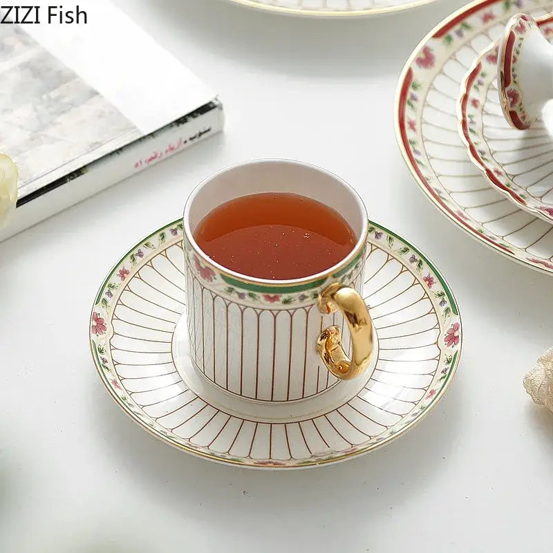 Classical gold-striped ceramic cup and saucer set in white porcelain with gold handle and pink floral rim design