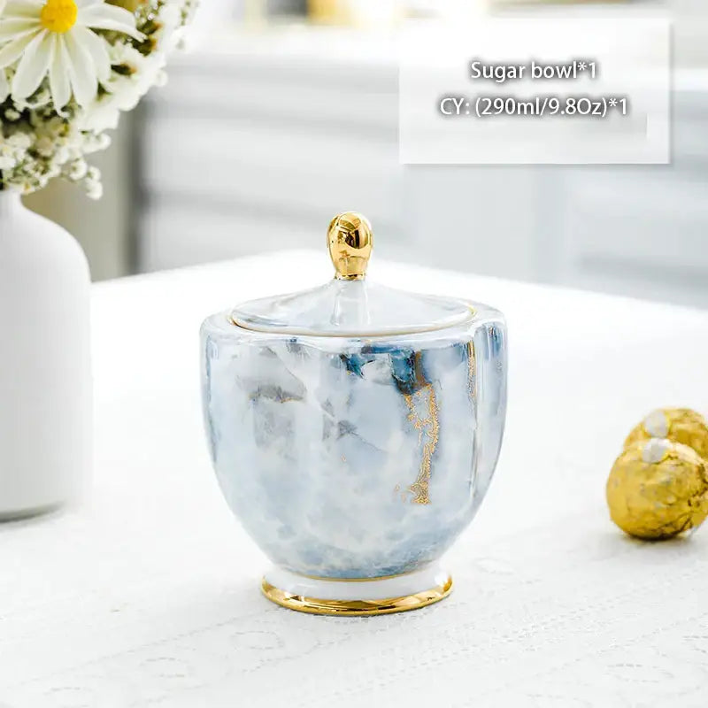 Classical gold trimmed bone china sugar bowl with blue and white marble pattern and gold accents from decorbites creamer set