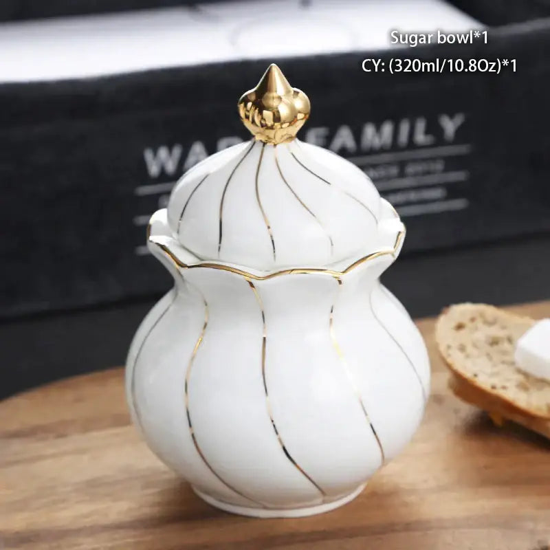 White ceramic sugar bowl with gold trim and golden spire lid from decorbites bone china creamer set