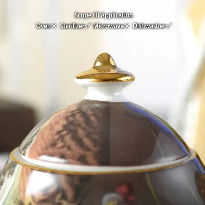 A glossy brown ceramic sugar bowl with gold-trimmed lid and decorative design from DecorBites bone china creamer set
