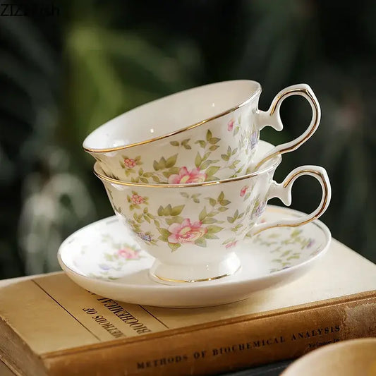 Classical ceramic cup and saucer set in white porcelain with pink rose pattern and gold trim for dining room decor