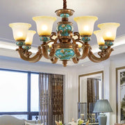 Classic resin chandelier with ornate bronze arms turquoise ceramic panels and cream glass shades by decorbites classical