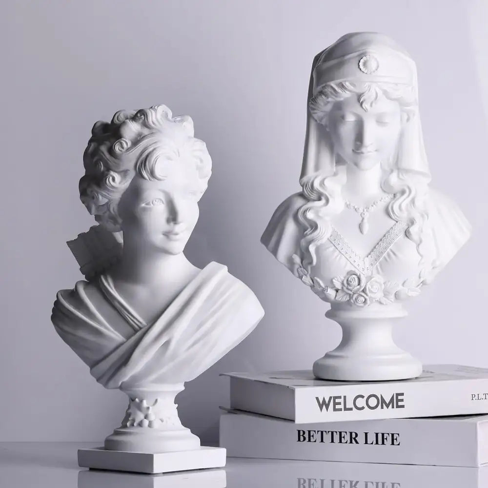 Two white classical cupid statue plaster bust sculptures with curly hair and floral veil for living room decor