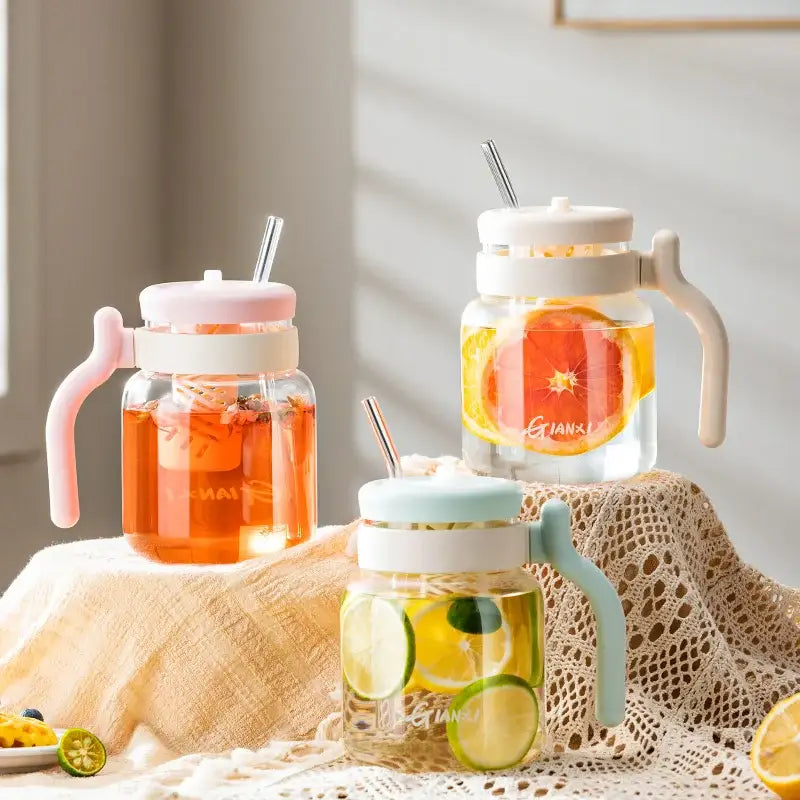 Three clear glass tumblers 1000ml with colorful silicone handles and lids filled with infused water decorbites 1000ml glass