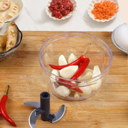 Clear 400ml mini food shredder with 3 blades and clear plastic bowl filled with garlic cloves and red chili peppers
