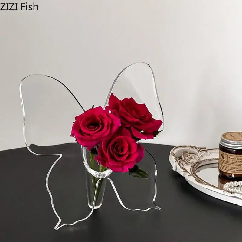 Clear acrylic butterfly vase by decorbites holding three vibrant red roses ideal for bedroom flower arrangement