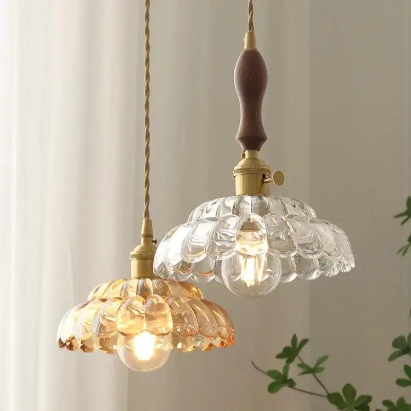 Two vintage-style pendant lamps with clear and decorbites amber glass shades and amber glass walnut wooden handles