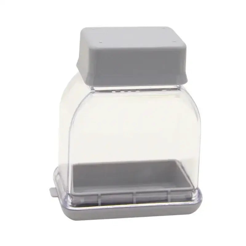 Clear plastic bird feeder with gray lid and base used as decorbites garlic grinding grater cutter kitchen tool accessory