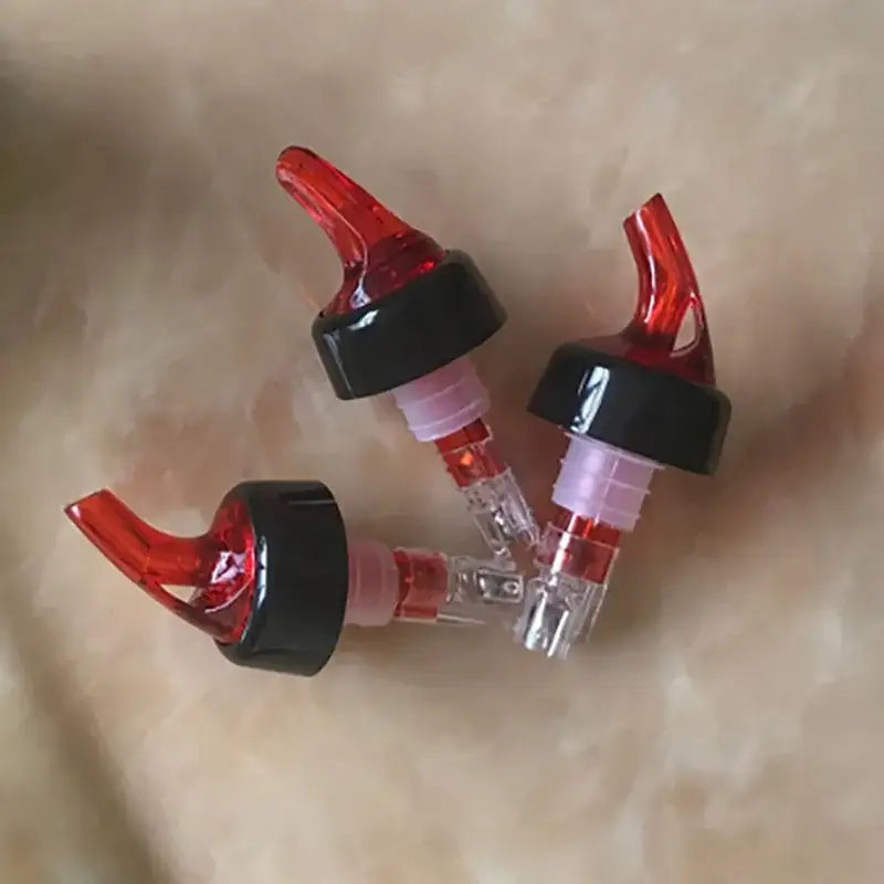 Clear and red plastic liquor pourer bottle dispenser with translucent bodies for decorbites liquor pourer use in kitchen barware