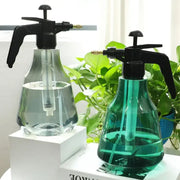 Clear and teal plastic hand trigger watering sprayer with black pump nozzles for garden and flower care
