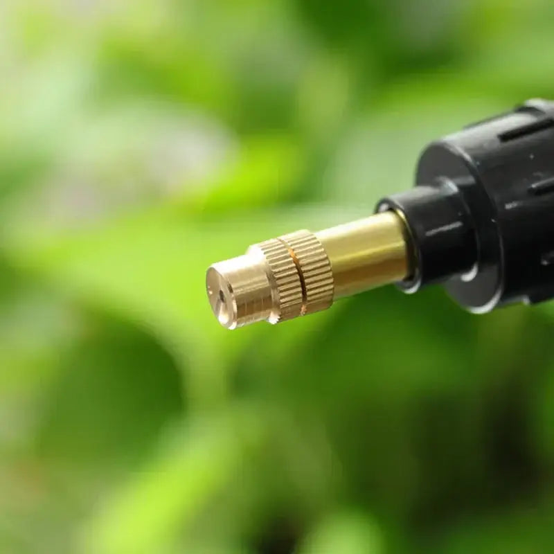 Gold-colored brass spray nozzle with black plastic housing for clear and teal hand trigger watering sprayer garden accessory