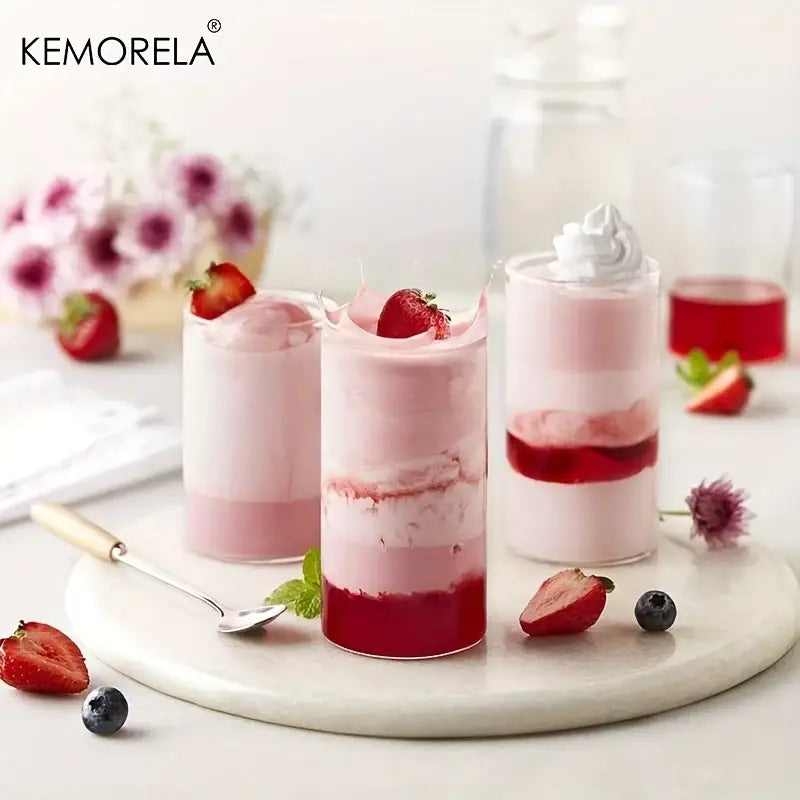 Three layered strawberry mousse desserts served in clear borosilicate drinking glasses from a drinking glasses set