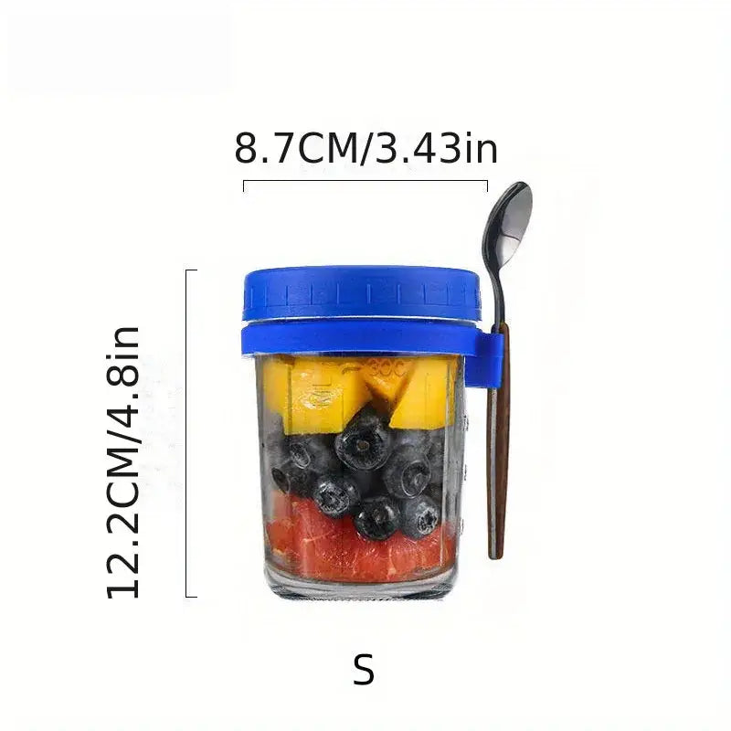 Clear borosilicate drinking glass jar with blue lid and side clip filled with colorful fruit slices from drinking glasses set