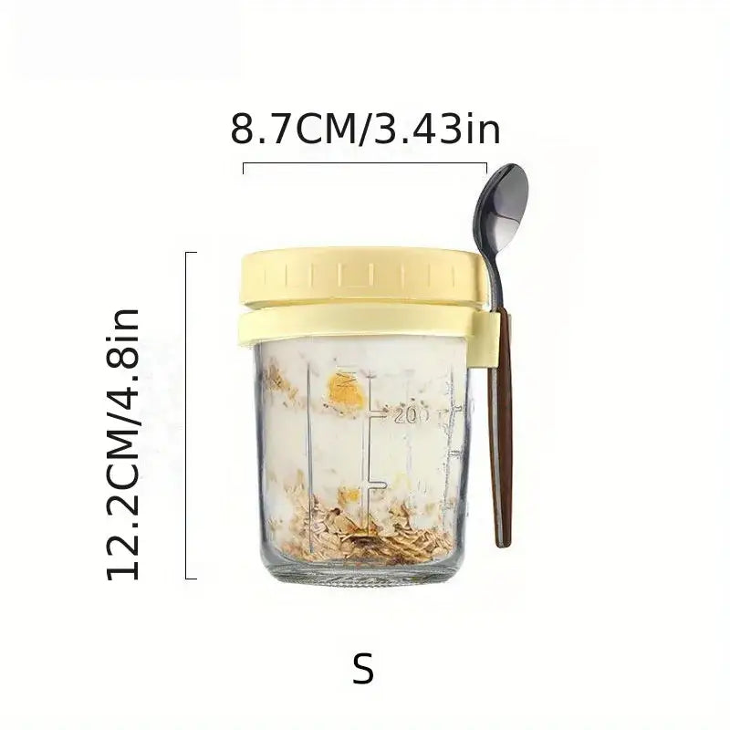Clear borosilicate drinking glass jar with pale yellow lid and handle containing oats with measurement markings