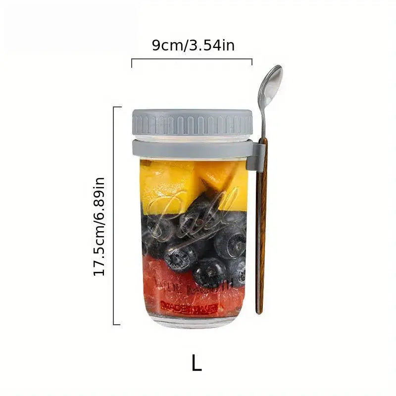 Clear borosilicate drinking glass jar with gray lid and spoon holder filled with layered fruit from a drinking glasses set