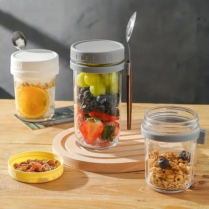 Clear borosilicate drinking glass jar with gray silicone lid filled with mixed berries from drinking glasses set