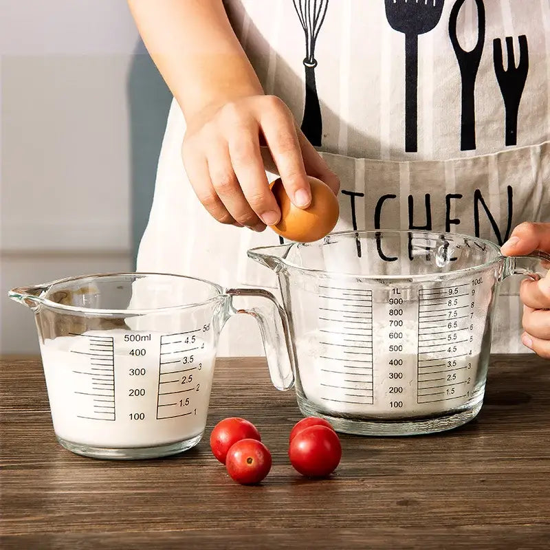 Clear borosilicate glass measuring cups with black markings holding milk and flour for kitchen baking by decorbites borosilicate glass