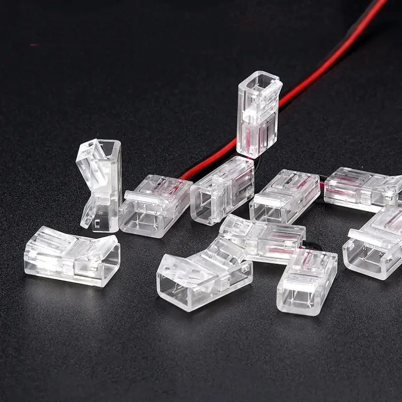 Clear plastic 2-pin l-shape cob led strip connectors with rectangular design and visible internal metal contacts