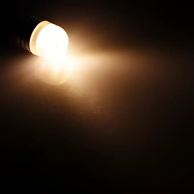 A warm glowing clear cylindrical led 3w cob bulb with a translucent white head and black body for living room decorbites g9 led lighting