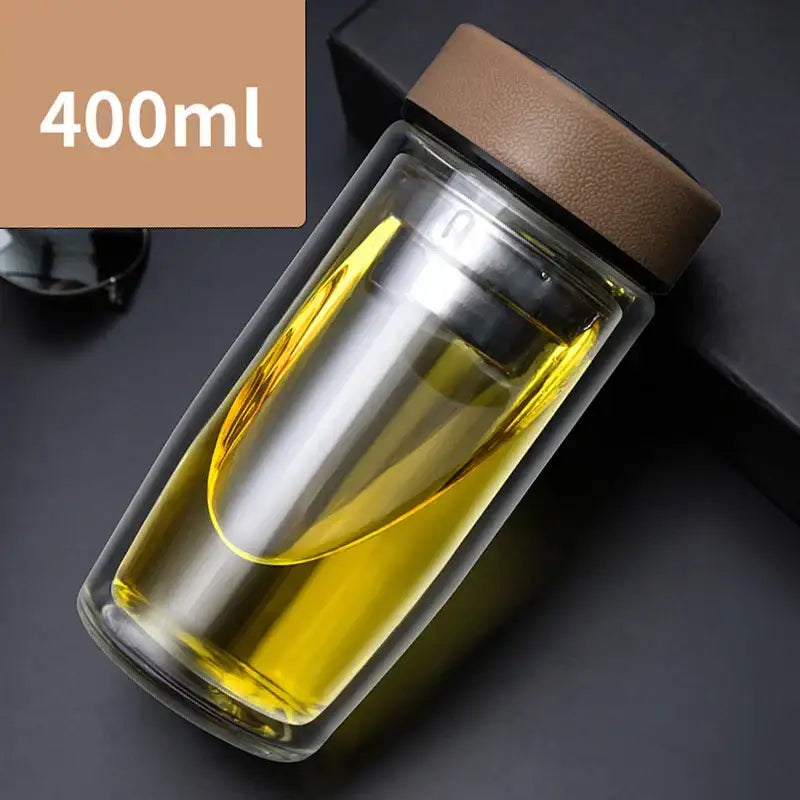 Clear double-walled glass travel mug with brown lid holding 400ml golden liquid featuring thermal insulation decorbites double-deck glass cups