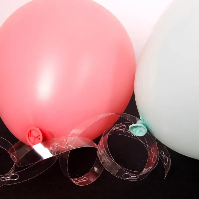 A translucent pink balloon with red valve and clear embossed ties for balloon arch garland kit party decor