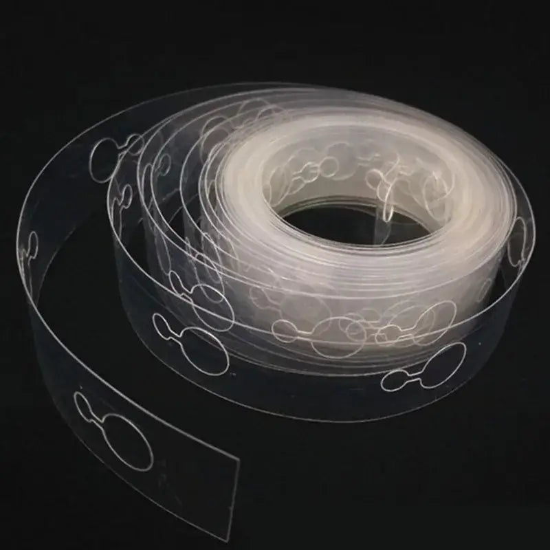 Clear plastic adhesive strip with white embossed circular and oval cutouts for balloon arch garland kit party decor