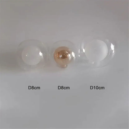 Three clear glass shade replacement globes with one rose gold and two white filaments for chandelier dining room use