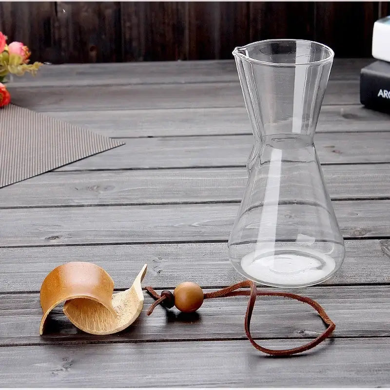 Clear glass barista kettle pot with narrow neck and wide base featuring smooth transparent surface for pour over coffee