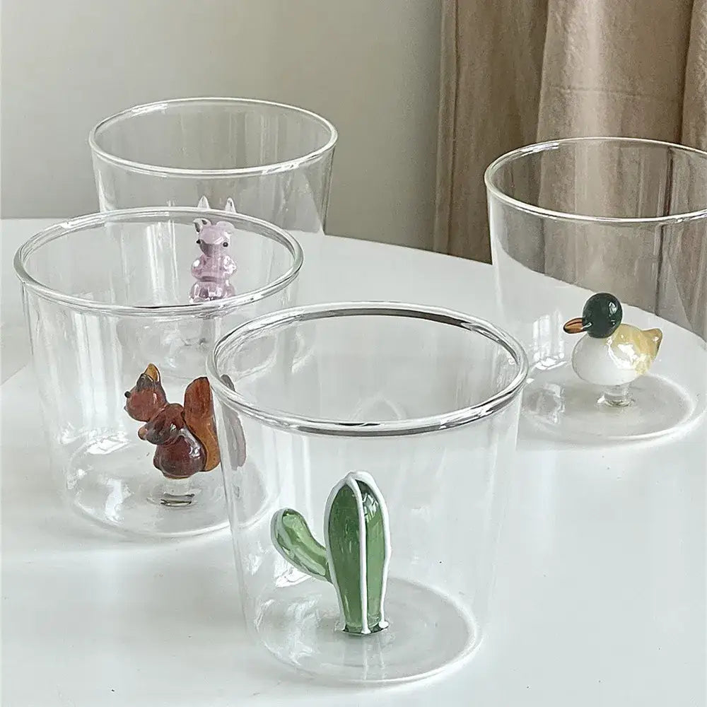 Clear glass cup with a green decorbites cactus bunny figurine attached for dining room drinkware use