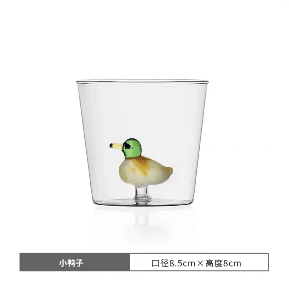 Clear glass cactus cup with hand-blown cactus bunny duckling figurine in green, yellow, and beige decorbites glass cup