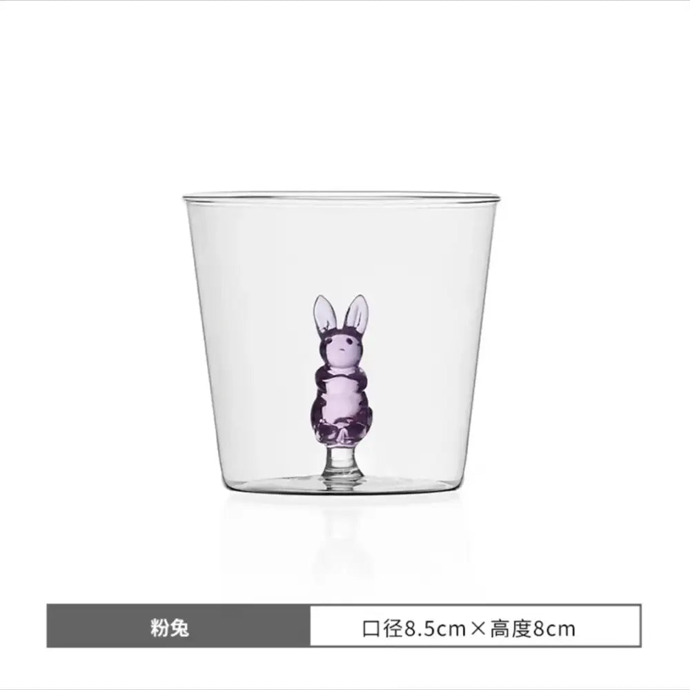 Clear glass cup with a translucent purple decorbites cactus bunny figurine molded into the base for dining room use