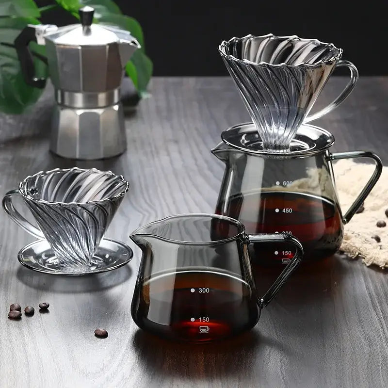 Clear glass coffee pot with measurement markings featuring a fluted glass coffee dripper with handle for brewing