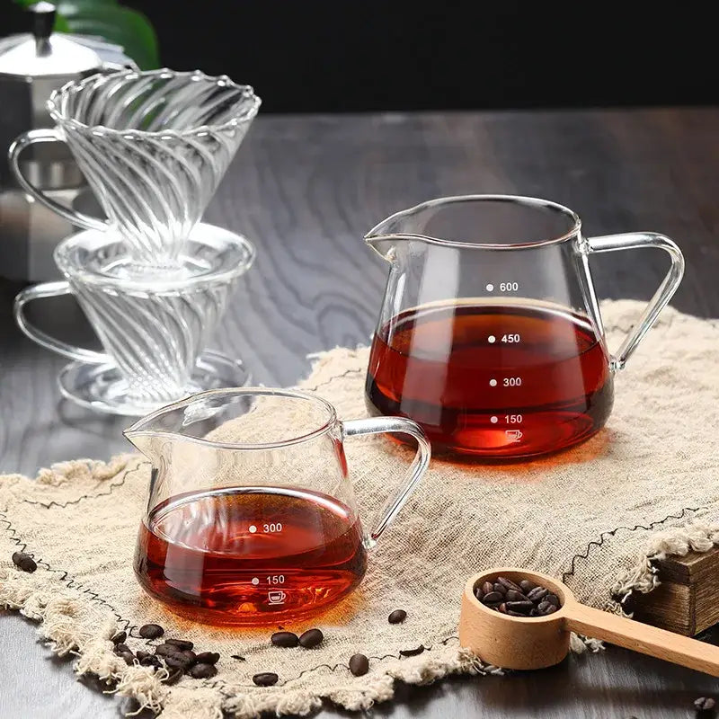 Clear glass coffee pot with twisted fluted pour-over dripper and measurement markings for precise brewing